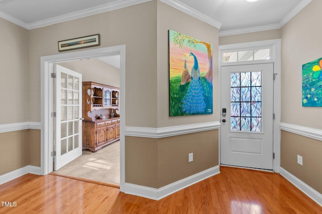 entryway with baseboards, wood finished floors, and ornamental molding