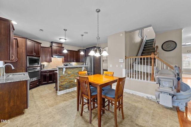 dining room featuring stairway, visible vents, baseboards, and a chandelier