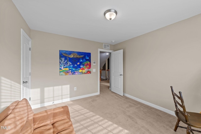 interior space with visible vents, baseboards, and light colored carpet