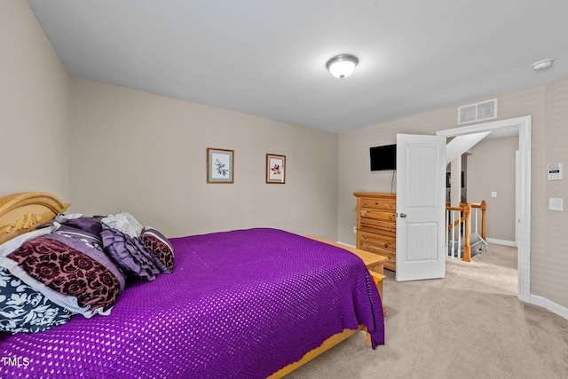 carpeted bedroom featuring visible vents and baseboards