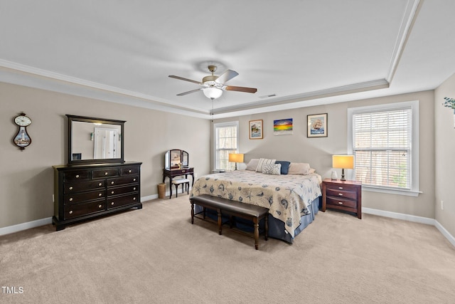 bedroom featuring a tray ceiling, carpet flooring, baseboards, and crown molding