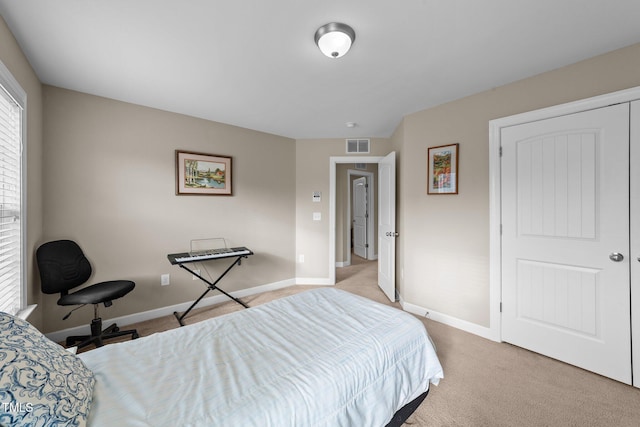 carpeted bedroom with visible vents and baseboards