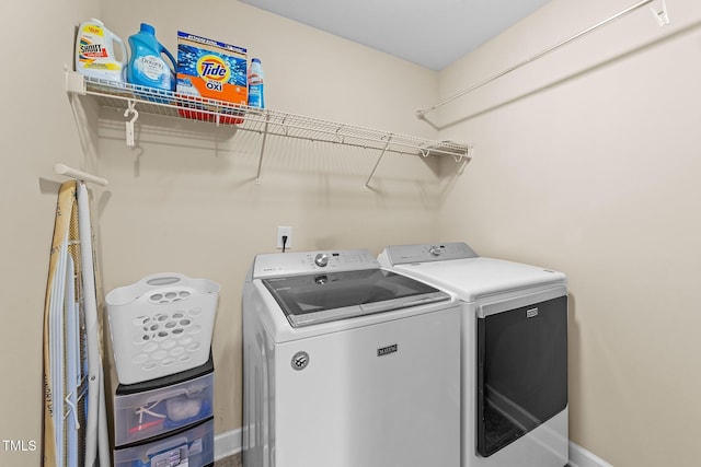 laundry room featuring laundry area, washer and dryer, and baseboards