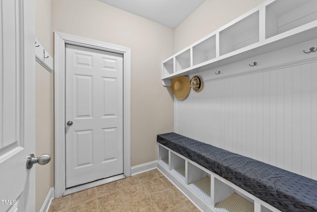 mudroom with light tile patterned floors and baseboards