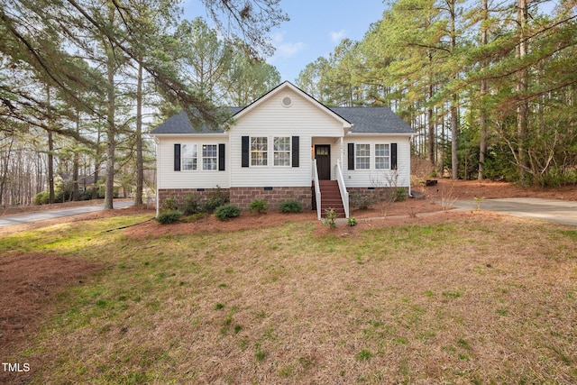 view of front of home with crawl space, a front yard, and roof with shingles