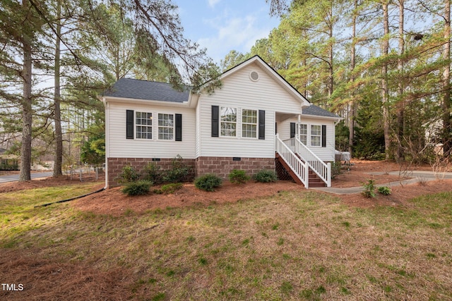 view of front of home with crawl space, a front yard, and roof with shingles