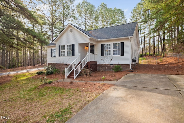 view of front of home with crawl space and a shingled roof