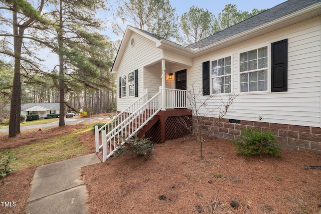 view of front of house featuring crawl space and a shingled roof