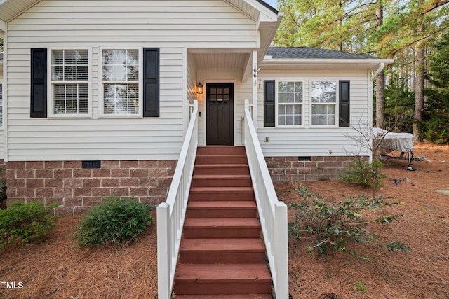 view of front of property with crawl space and a shingled roof