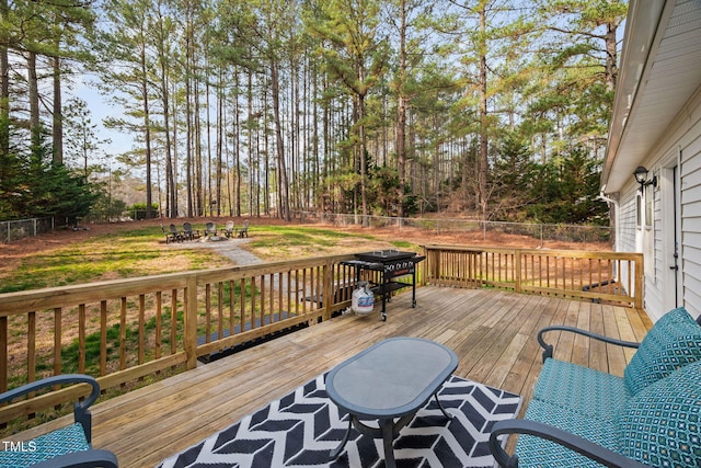 wooden terrace with a yard and fence