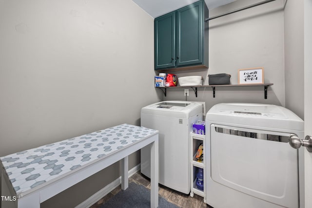 clothes washing area with washing machine and clothes dryer and cabinet space