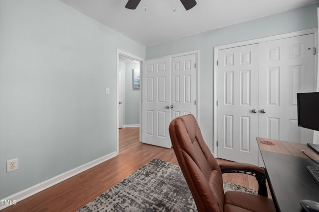 office featuring baseboards, a ceiling fan, and wood finished floors