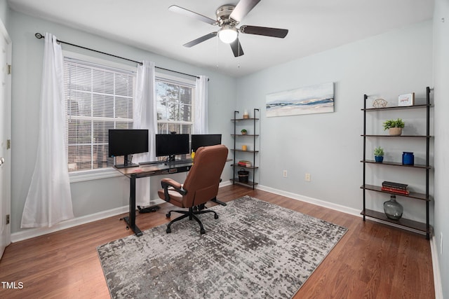 office area with baseboards, a ceiling fan, and wood finished floors