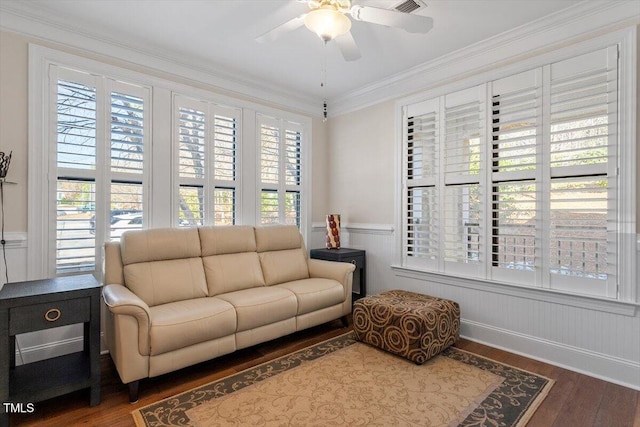 living area featuring crown molding, wood finished floors, a wealth of natural light, and ceiling fan