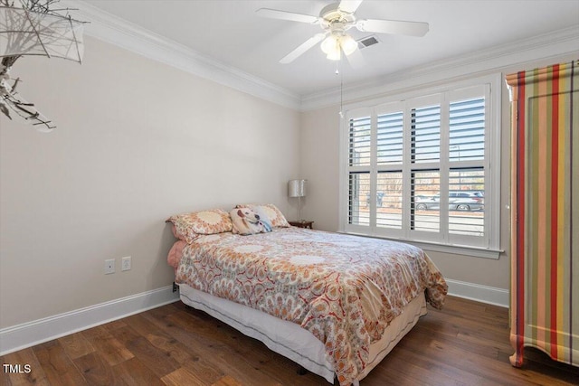 bedroom featuring crown molding, wood finished floors, baseboards, and visible vents