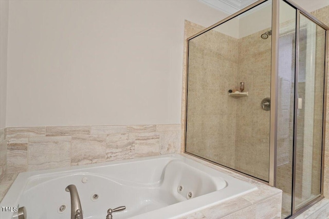 full bath with a tub with jets, a stall shower, and ornamental molding