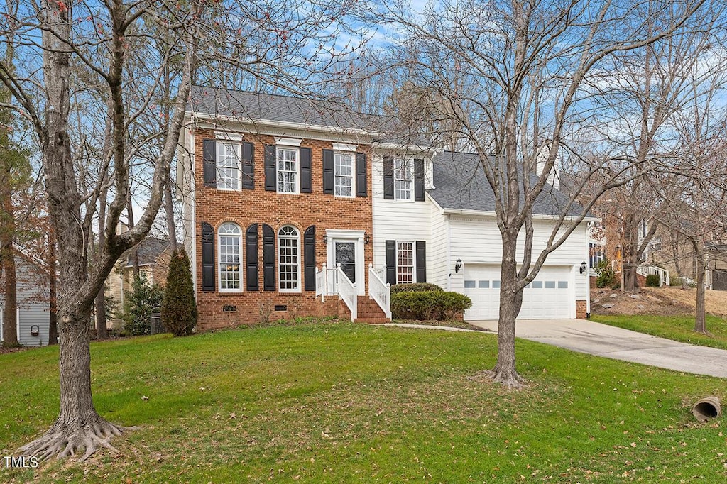 colonial-style house with brick siding, concrete driveway, crawl space, roof with shingles, and a front lawn