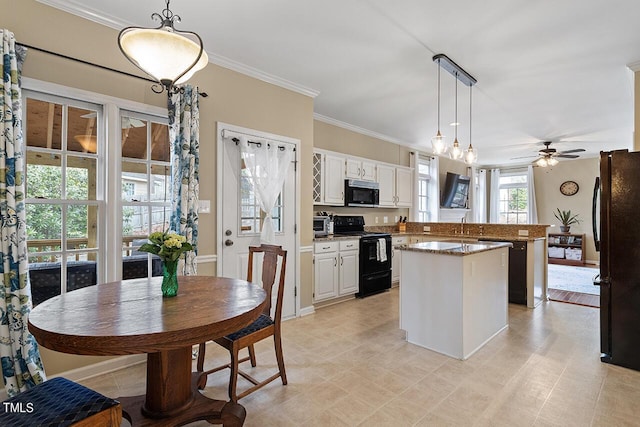 kitchen featuring a peninsula, a kitchen island, white cabinets, ornamental molding, and black appliances