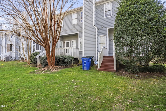 rear view of property featuring a yard