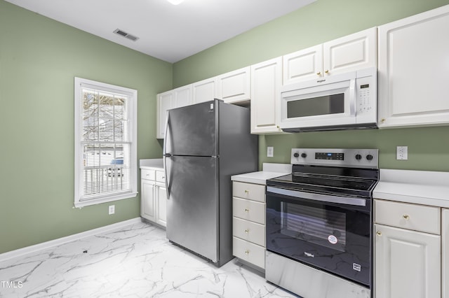 kitchen with stainless steel appliances, visible vents, white cabinets, marble finish floor, and light countertops