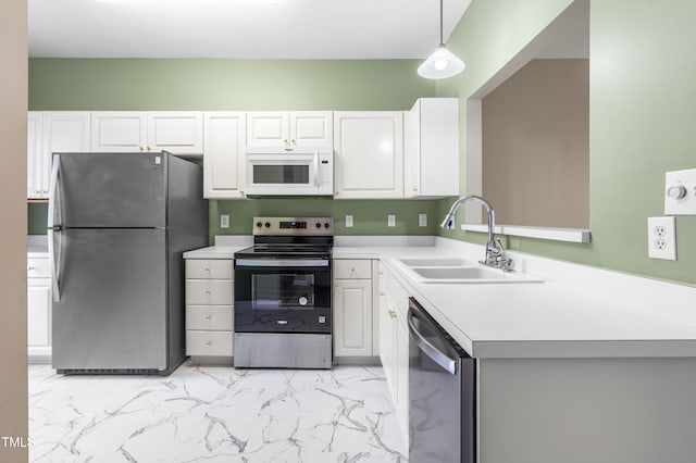 kitchen featuring stainless steel appliances, a sink, white cabinets, marble finish floor, and light countertops