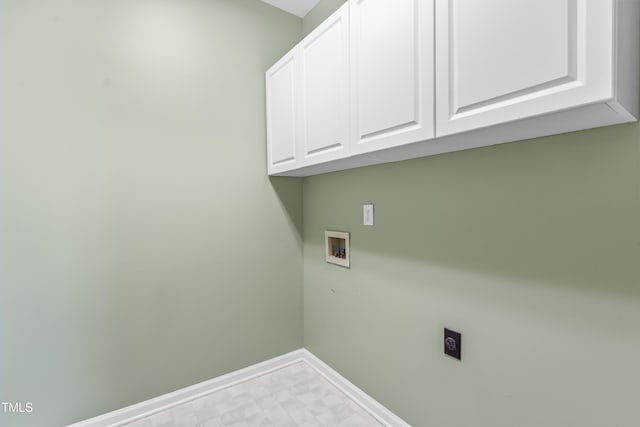 laundry room featuring hookup for a washing machine, baseboards, cabinet space, tile patterned floors, and electric dryer hookup