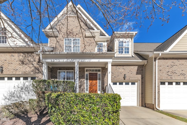 view of front of house featuring concrete driveway, brick siding, and an attached garage