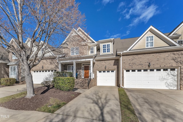 view of front of house featuring a garage, concrete driveway, and brick siding