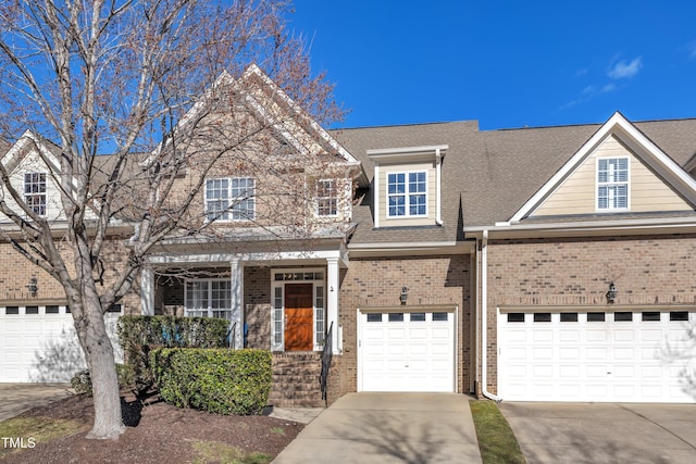 view of front of home with driveway, a shingled roof, a garage, and brick siding