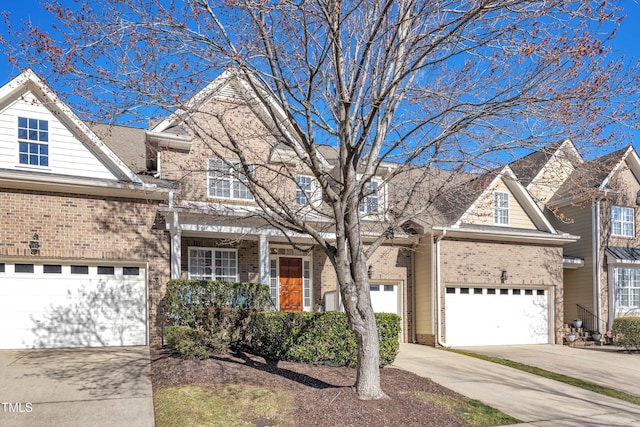 view of front of house with concrete driveway, brick siding, and an attached garage