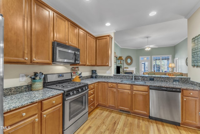 kitchen featuring appliances with stainless steel finishes, visible vents, a sink, and ornamental molding