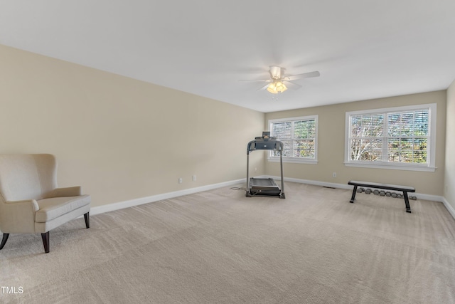 workout area with carpet floors, a ceiling fan, and baseboards