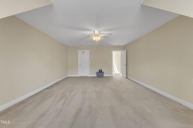 spare room featuring baseboards and light colored carpet