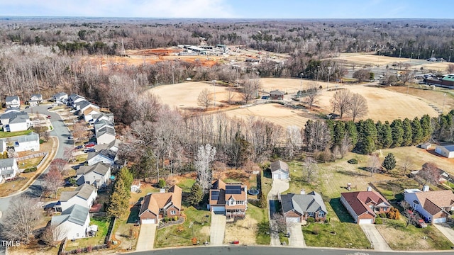 bird's eye view featuring a residential view and a wooded view