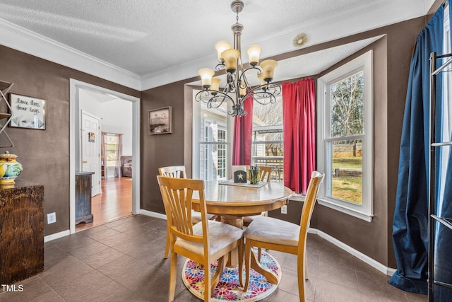 tiled dining room with a wealth of natural light, a notable chandelier, a textured ceiling, and crown molding