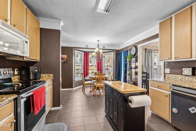 kitchen with visible vents, butcher block counters, appliances with stainless steel finishes, a notable chandelier, and dark cabinets