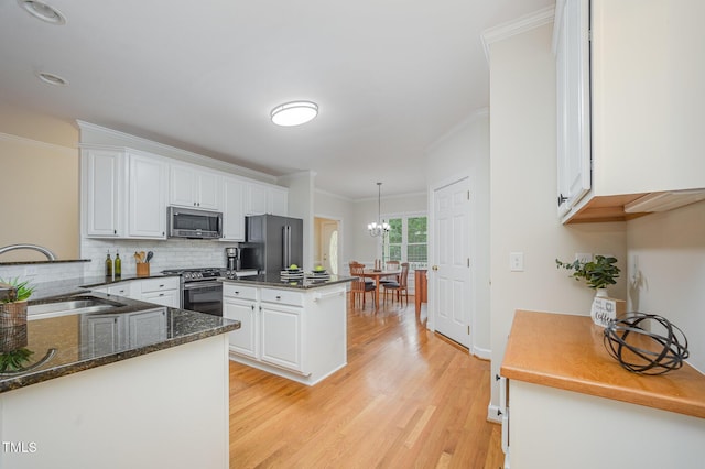 1208 Dunn Creek Xing, Wake Forest, NC 27587 - kitchen featuring stainless steel appliances, a sink, ornamental molding, and white cabinetry