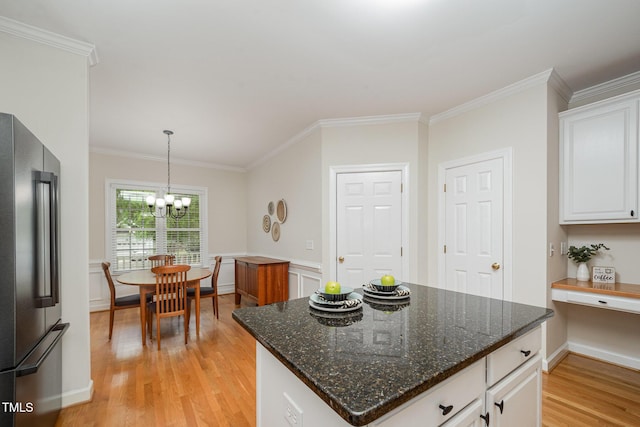 1208 Dunn Creek Xing, Wake Forest, NC 27587 - kitchen featuring high end fridge, light wood-style floors, white cabinets, a chandelier, and crown molding