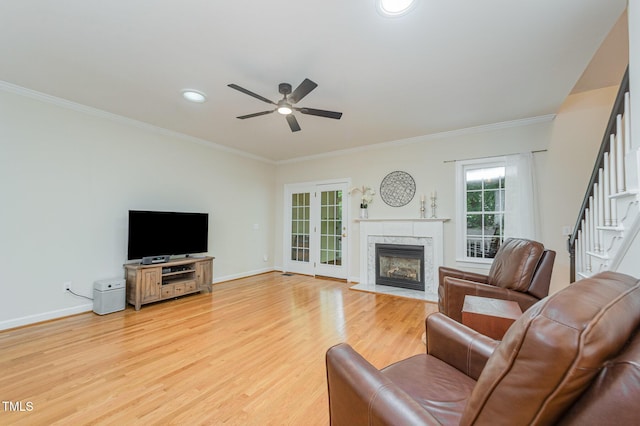 1208 Dunn Creek Xing, Wake Forest, NC 27587 - living area with ceiling fan, a premium fireplace, light wood finished floors, crown molding, and baseboards