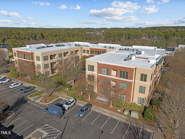 birds eye view of property with a wooded view