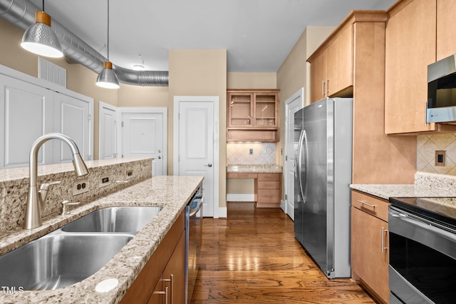 kitchen featuring open shelves, appliances with stainless steel finishes, decorative backsplash, and a sink