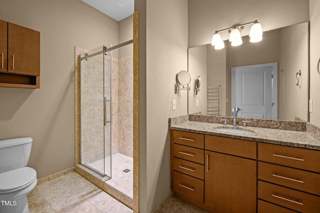 bathroom with tile patterned flooring, toilet, vanity, baseboards, and a shower stall