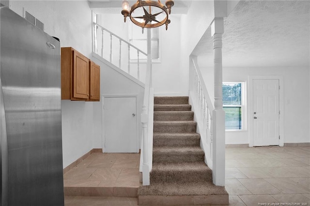 173 Style Dr, Parkton, NC 28371 - staircase featuring tile patterned floors, a textured ceiling, and baseboards
