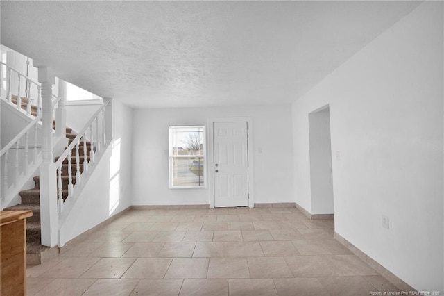 173 Style Dr, Parkton, NC 28371 - unfurnished room with a textured ceiling, stairs, and baseboards