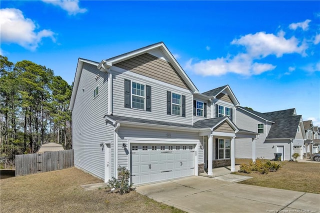 traditional home featuring driveway, an attached garage, and fence