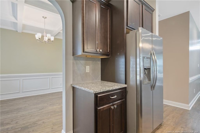 kitchen with light wood finished floors, stainless steel refrigerator with ice dispenser, coffered ceiling, and dark brown cabinetry