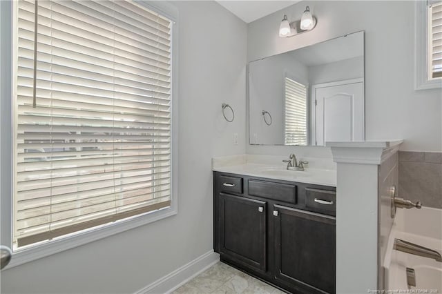 full bath featuring vanity and baseboards