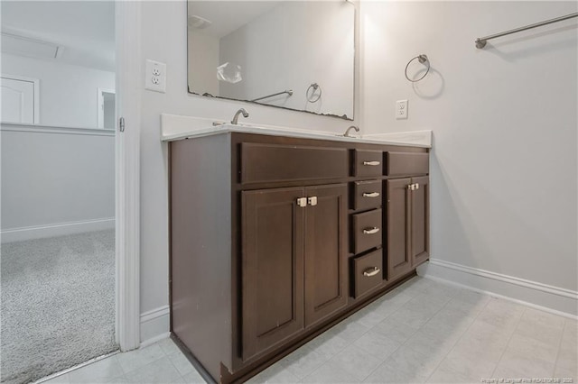 bathroom featuring double vanity and baseboards