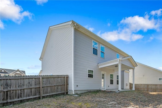 rear view of property with fence