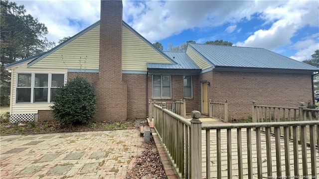 107 Oakmont Dr, Clinton, NC 28328 - rear view of house with brick siding and a chimney